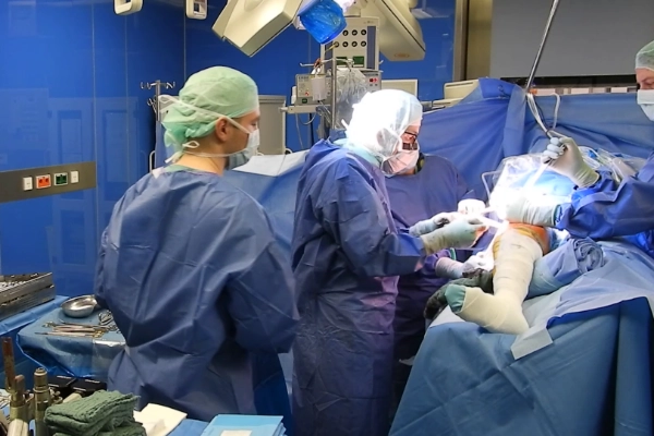 Surgeons in operating theatre performing an arthroplasty